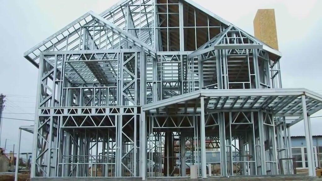 Steel frame of a pitched-roof house with trussed floors and roof