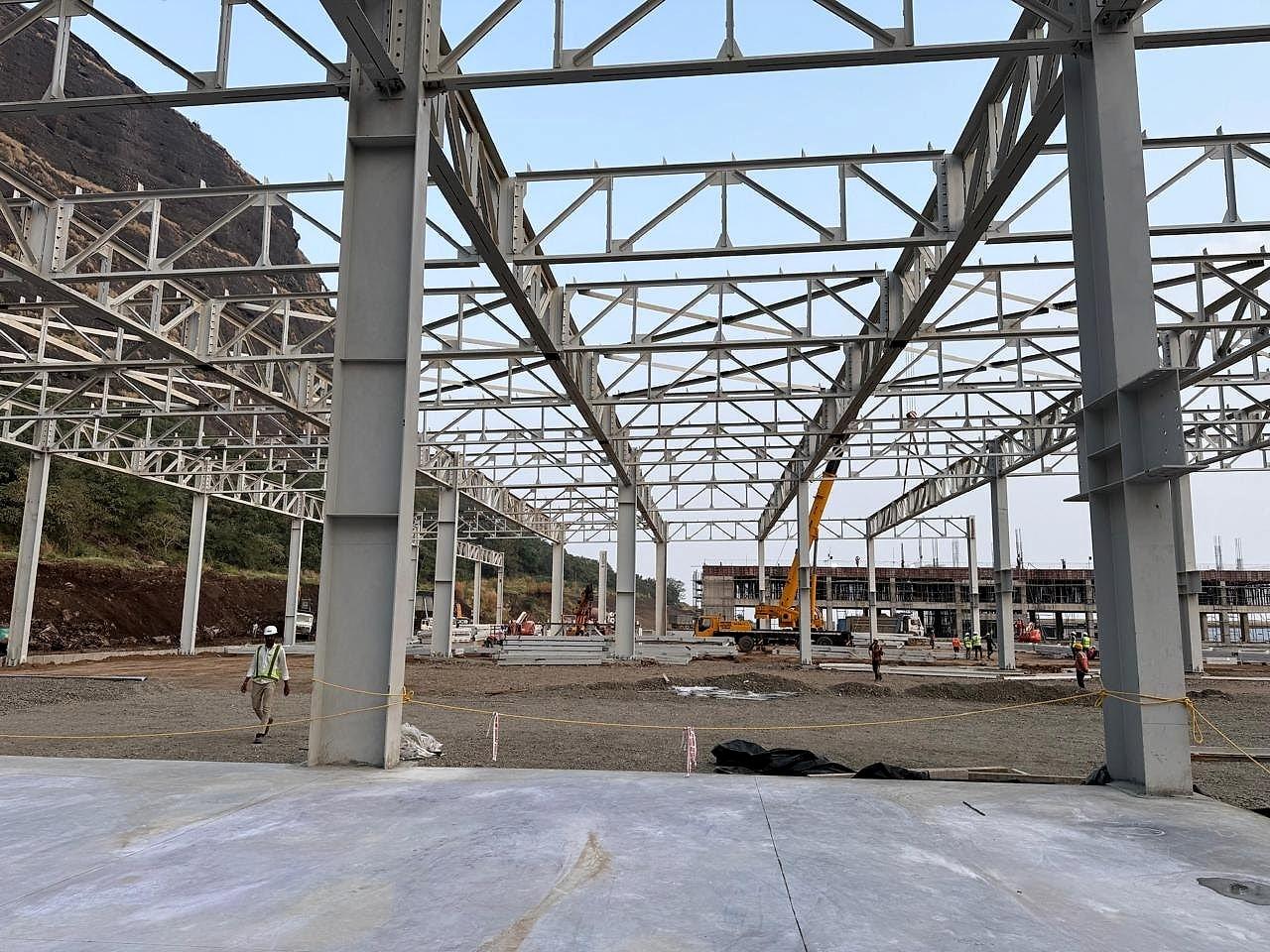 Built-up steel columns and long-span roof trusses across the PEB hall at the Hyundai plant, Pune