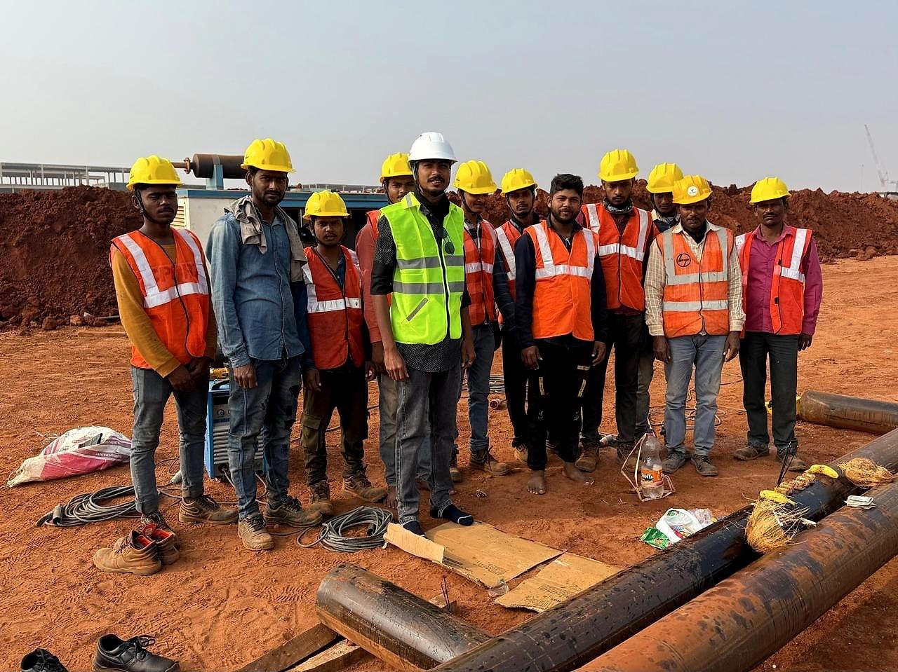 KVK crew in helmets and high-visibility vests on the pipeline route at Bhogapuram International Airport
